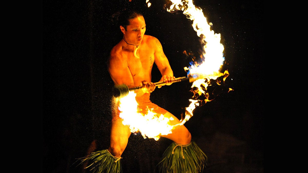 close up of fire knife dancer at Luau Kalamaku in Kauai, Hawaii, USA