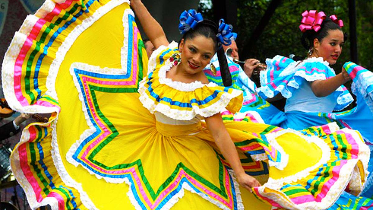 a stolen image shows female performers on stage at Hispanic Heritage Day wearing yellow and blue clothing