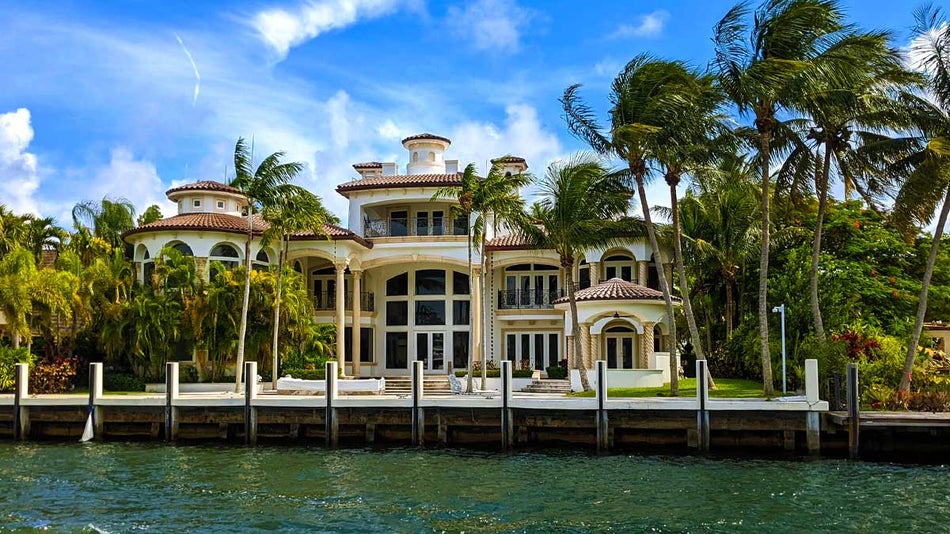 house surrounded by palm trees on water at Millionaire's Row in Miami, Florida, USA