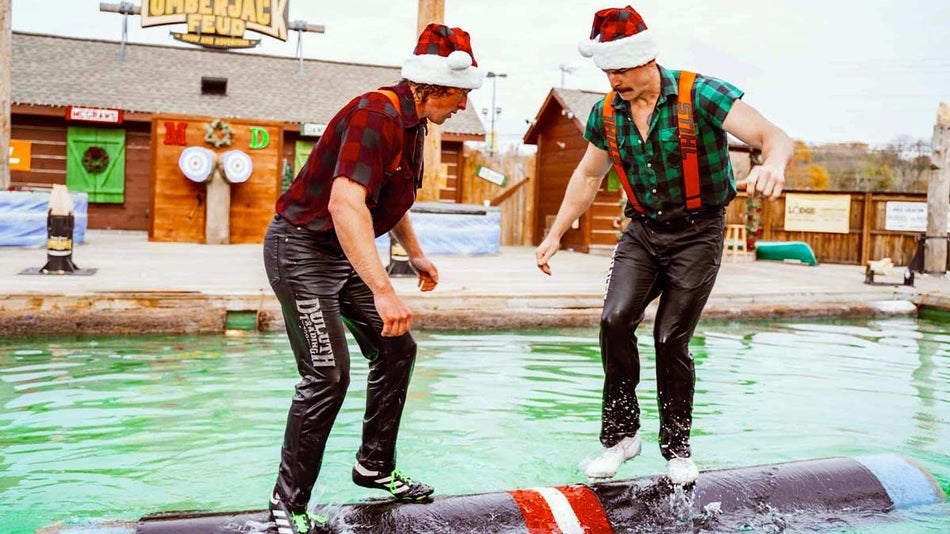 performers balancing on log in pool wearing santa hats at Paula Deen's Lumberjack Feud Christmas Show in Pigeon Forge, Tennessee, USA