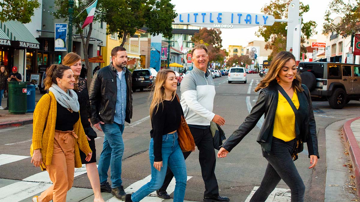 A picture of a group of people happily crossing the road