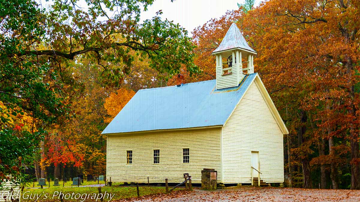exterior of Primitive Baptist Church Cades Cove during fall with trees in background during day at Gatlinburg, Tennessee, USA