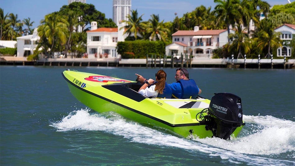 couple on neon green speed boat with view of houses and trees in distance during day for San Diego Speed Boat Adventures in San Diego, California, USA