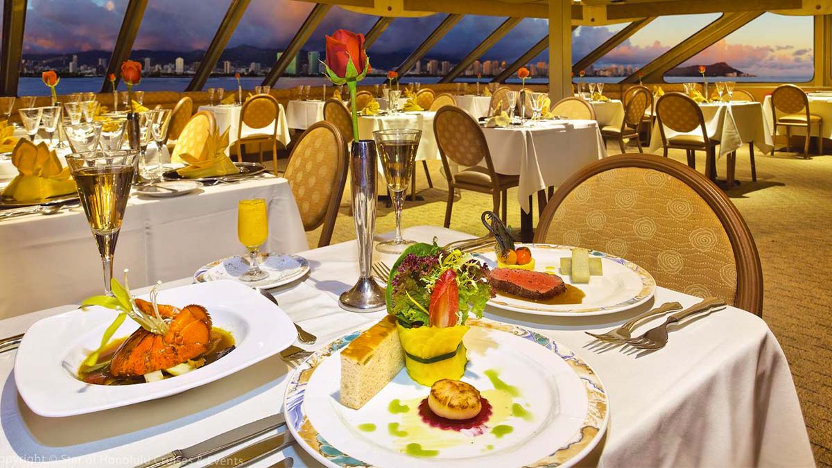 close up of plates of food on table at Star of Honolulu Sunset Dinner Cruise in Oahu, Hawaii, USA