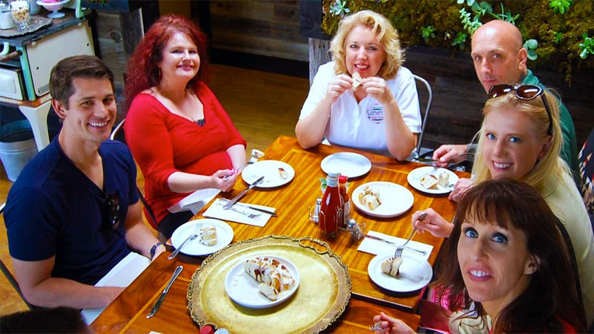 A group picture of people eating in a restaurant