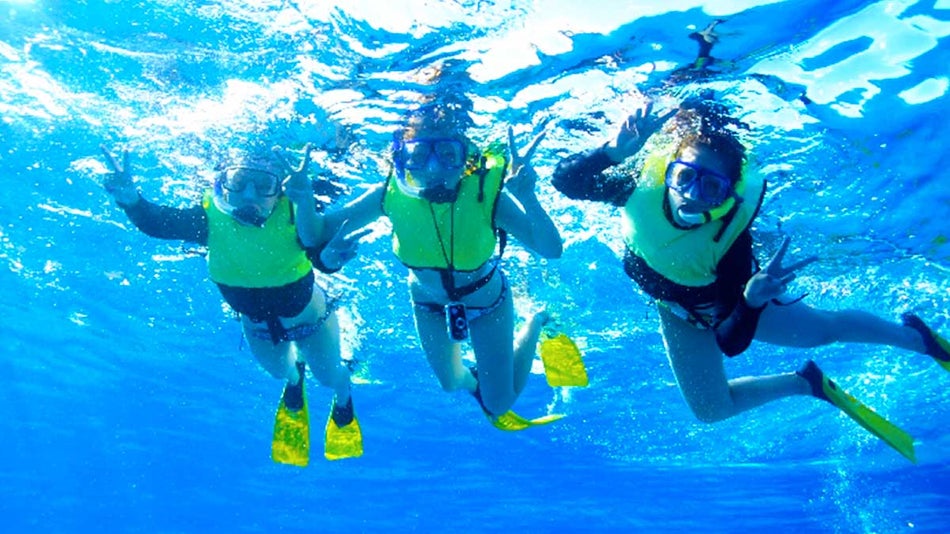 snorkelers posing for photo underwater