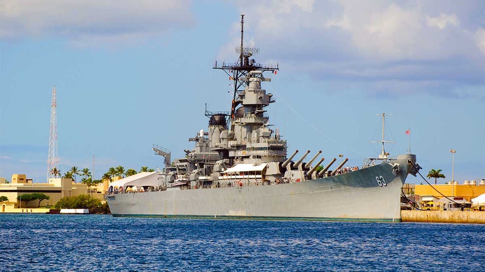 wide shot of uss missouri battleship in the harbor 