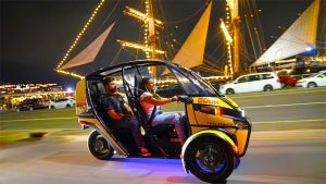 couple on GoCar driving around at night in San Diego, California, USA