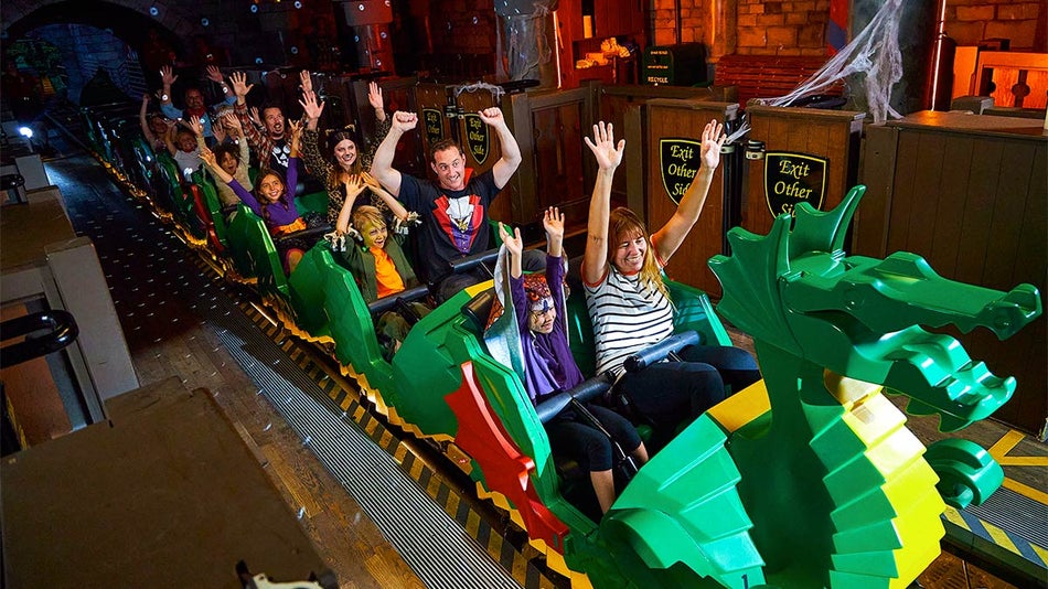 A photo of a multiple people enjoying the monster dragon ride in California