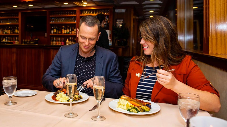 A man and woman enjoying a delicious meal at a restaurant. 