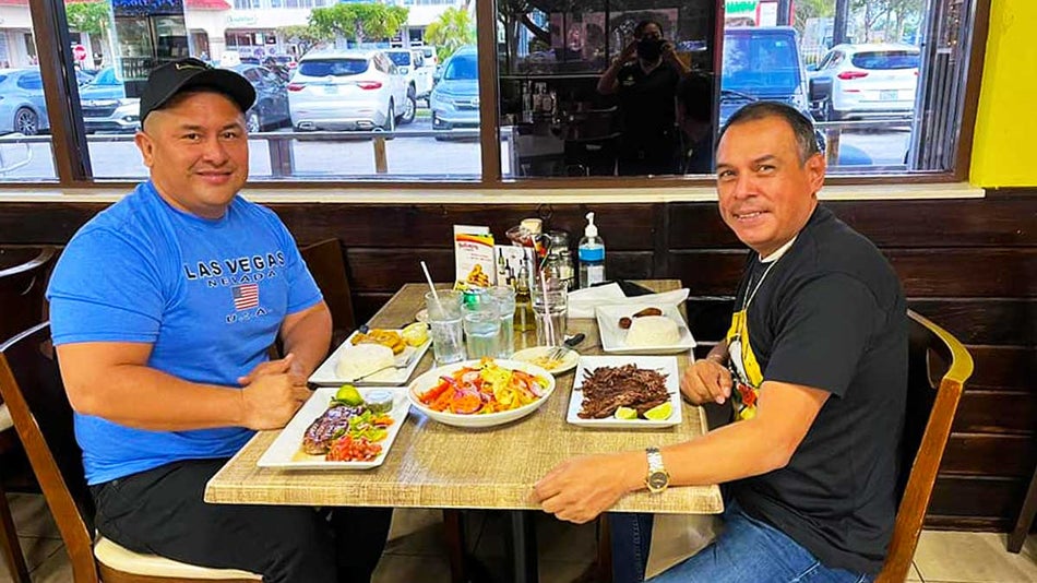 A photo of two men having a meal at Safari Cafe in Everglades Safari Park.