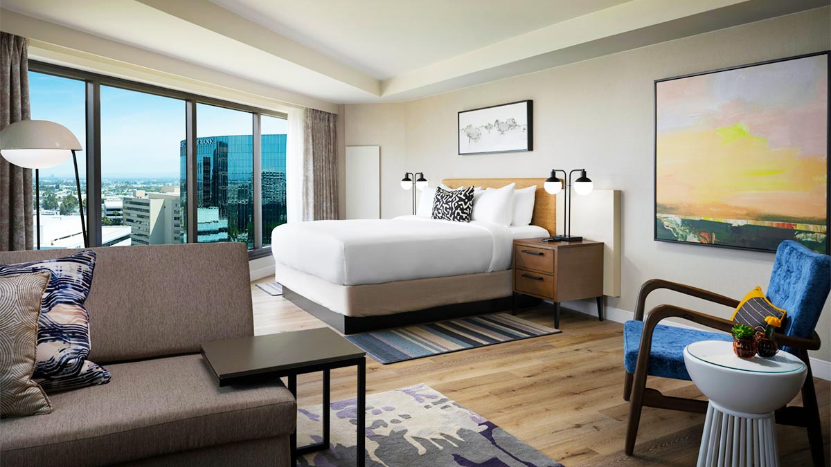 guest room at Sonesta Irvine with white walls furniture and paintings and rugs in Los Angeles, California, USA