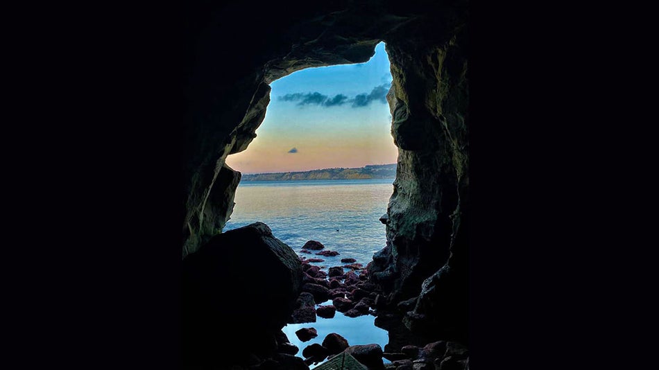 opening of Sunny Jim Sea Cave La Jolla Sea Cave taken from inside cave with view of ocean during sunset in San Diego, California, USA