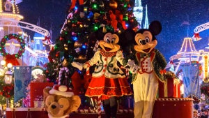 close up of minnie and mickey mouse mascots on float with large christmas tree at night at Mickey's Very Merry Christmas Party in Orlando, Florida, USA
