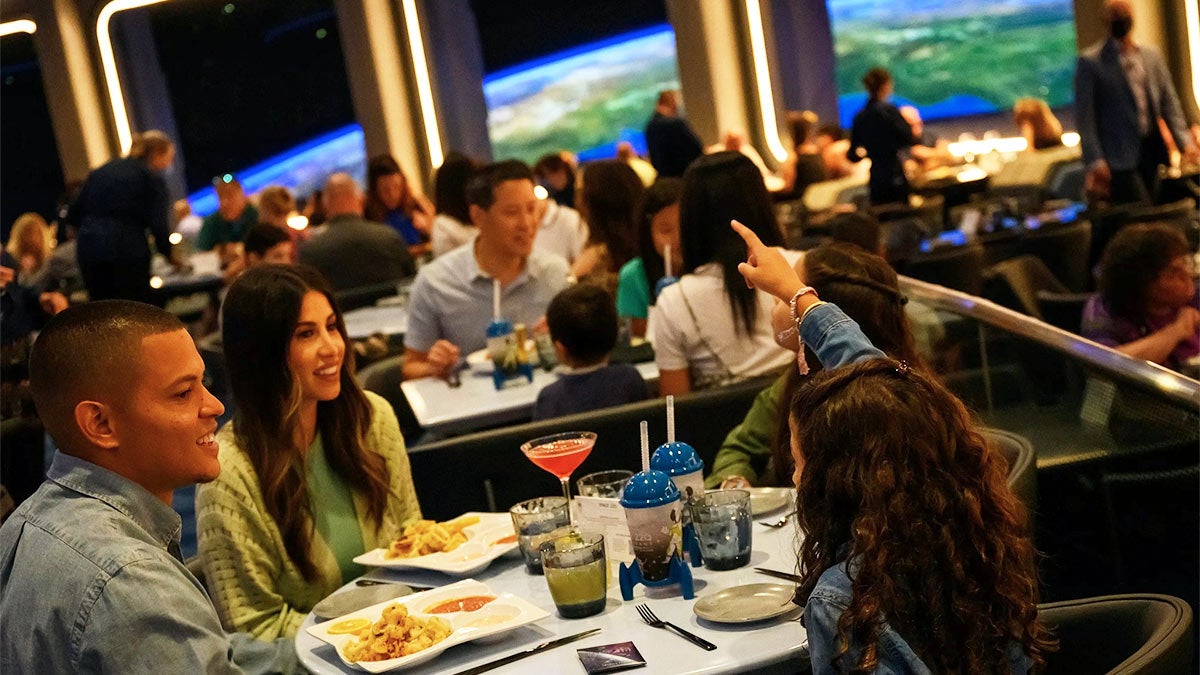families dining at Space 220 restaurant at Epcot in Orlando, Florida, USA