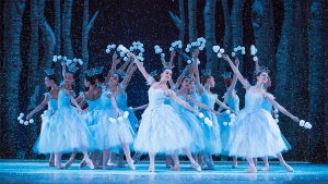 ballet dancers on stage with light blue dresses and tiaras holding white flowers for The Nutcracker at New York City Ballet in New York City, New York, USA