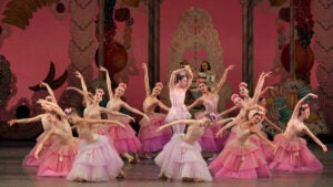 ballet dancers on stage in dresses in various shades of pink with flowers in hair for The Nutcracker production at New York City Ballet in New York City, New York, USA