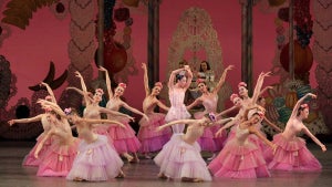 ballet dancers on stage in dresses in various shades of pink with flowers in hair for The Nutcracker production at New York City Ballet in New York City, New York, USA