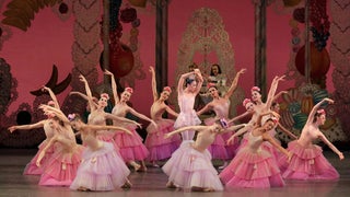 ballet dancers on stage in dresses in various shades of pink with flowers in hair for The Nutcracker production at New York City Ballet in New York City, New York, USA