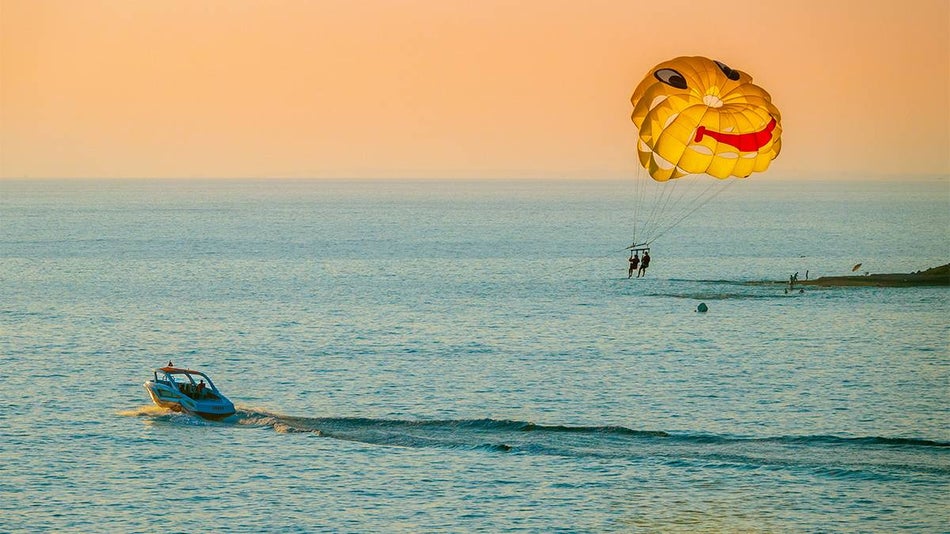 kids parasailing over ocean