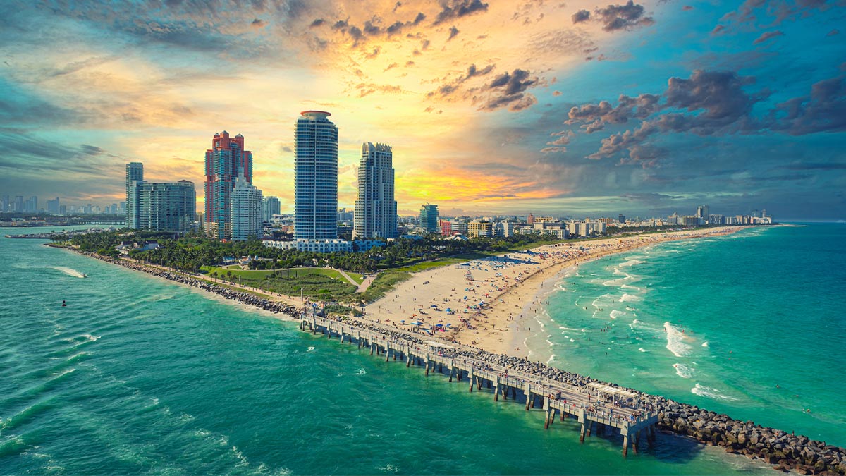 south beach during sunset with view of buildings, shore, water in Miami, Florida, USA