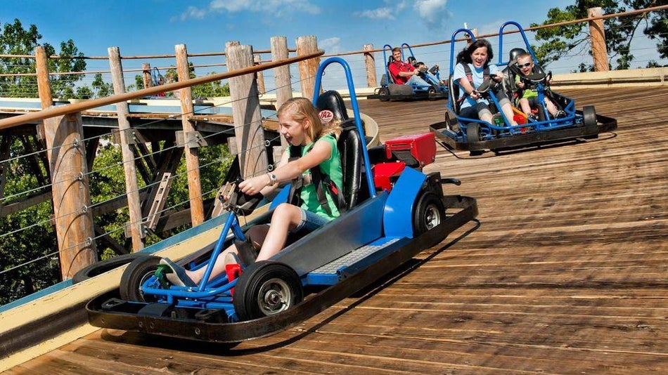 family racing around The Track in go carts in Branson, Missouri, USA