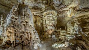 Wide shot of very large and very old rock formation inside of a cave at Natural Bridge Caverns in San Antonio, Texas