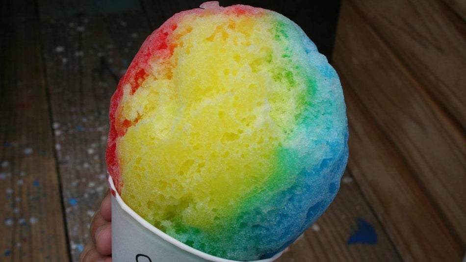 Close up of a person holding a rainbow shave ice on Oahu, Hawaii, USA