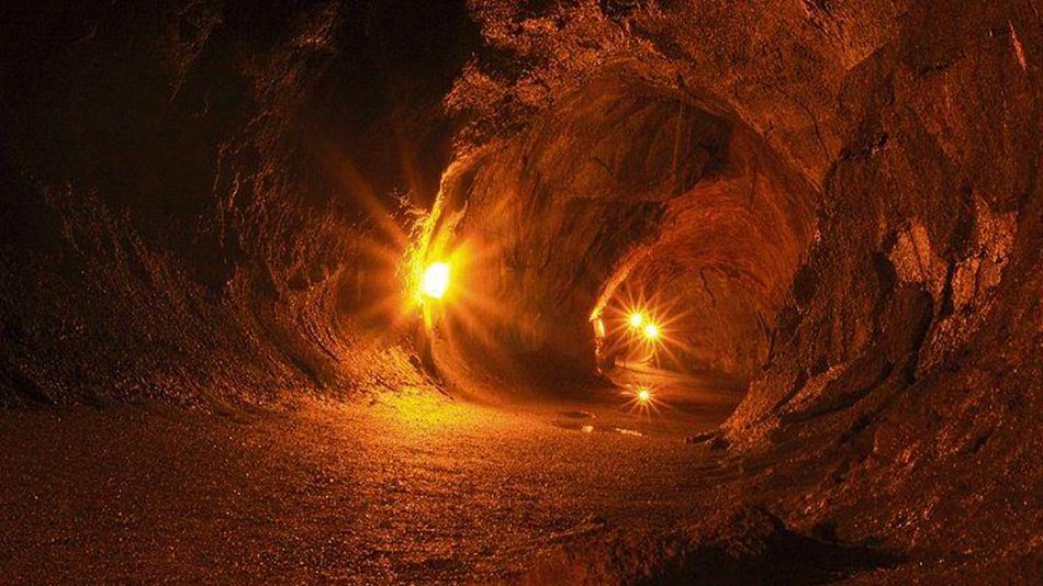 underground tunnel with lights inside of the Nāhuku Thurston Lava Tube in Big Island, Hawaii, USA
