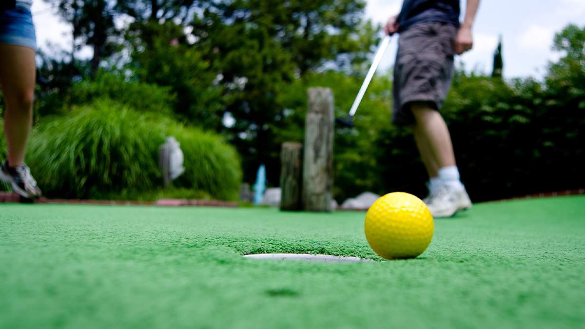 Two people playing mini golf at Frankies Fun Park in Charleston, North Carolina, USA.