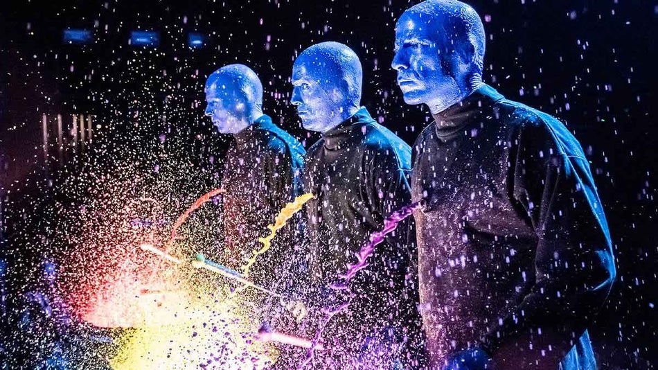 three performers with colorful drums at Blue Man Group in Chicago, Illinois, USA