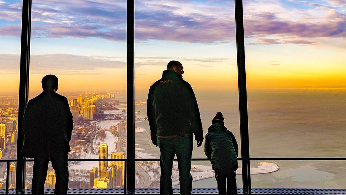 Father and child viewing the city at 360 Chicago during sunset - Chicago, Illinois, USA