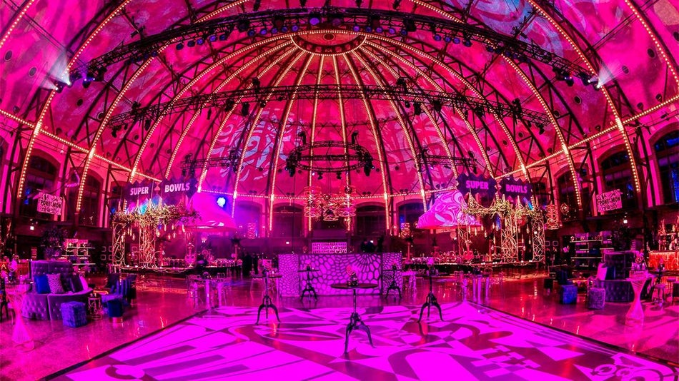 Wide shot of the Son Grand Ballroom blanketed in pink light for Year on the Pier at Navy Pier in Chicago, Illinois, USA