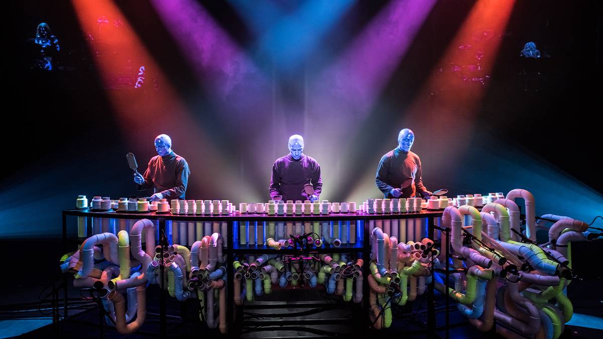 close up of three Blue Man Group performers on stage with lights in Chicago, Illinois, USA