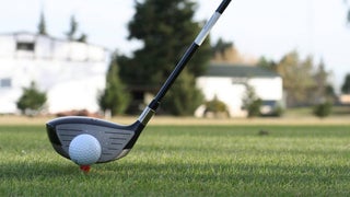 Golf Club and Ball on The Green