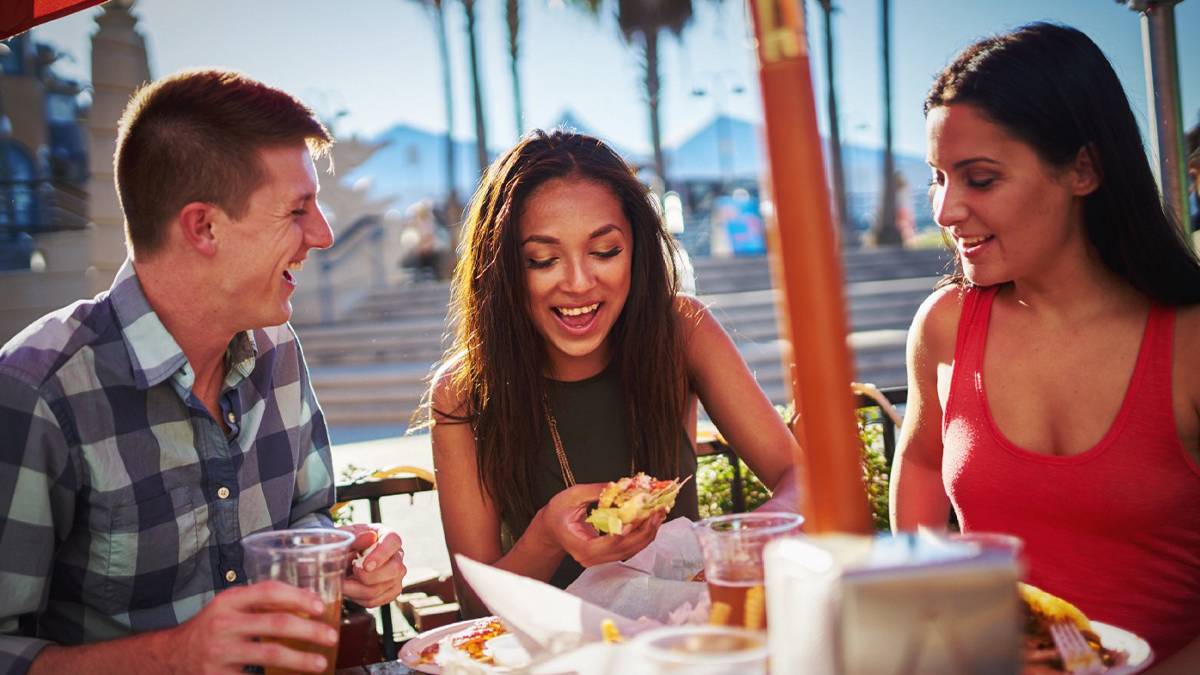 Family eating food outdoors at Disneyland’s Food & Wine Festival