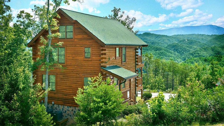 exterior view of Hearthside Cabin Rentals with Great Smoky Mountains in background in Pigeon Forge, Tennessee, USA