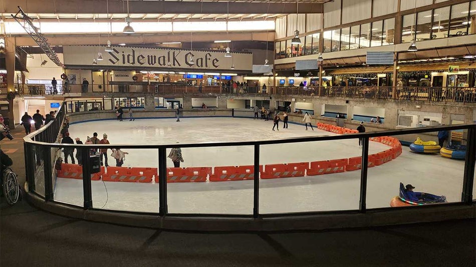 Wide shot of Ober Gatlinburg-Ice Skating Arena with people on the ice and a cafe in the back in Gatlinburg, Tennessee, USA