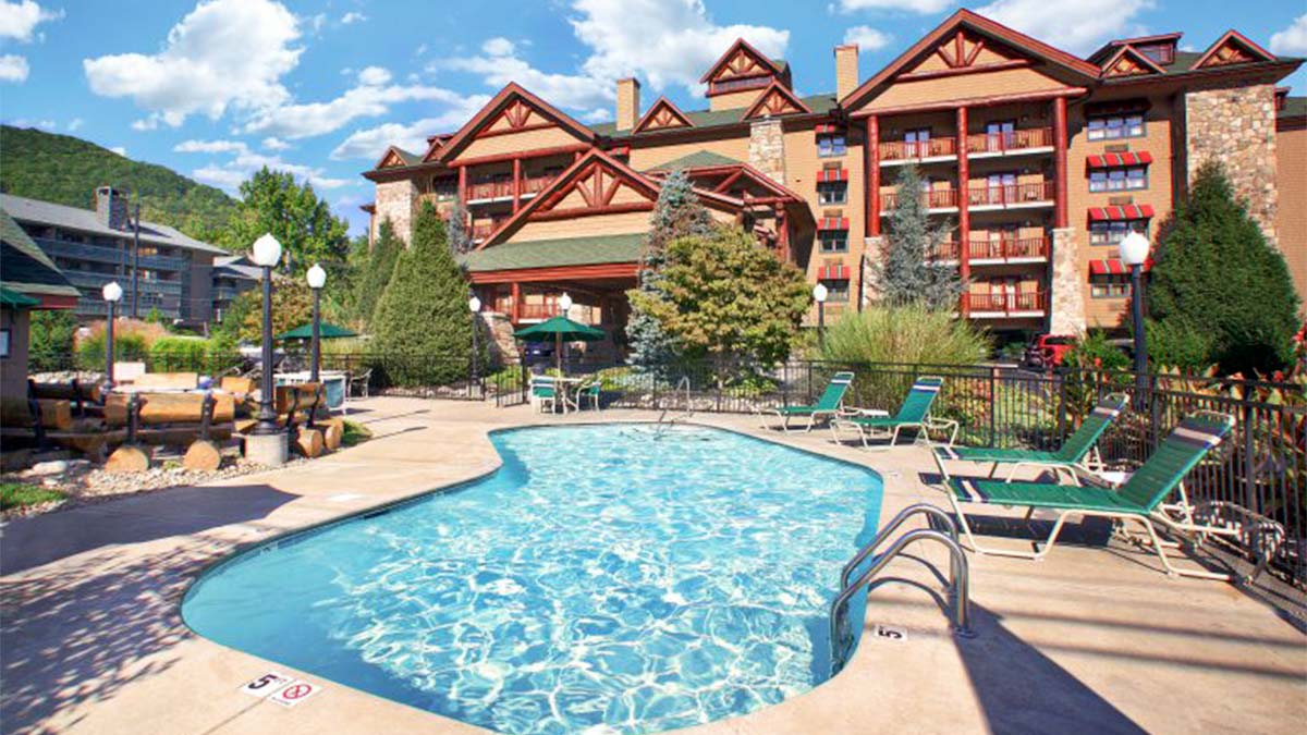 Ground view of outdoor pool exterior of Bearskin Lodge on the River in Gatlinburg, Tennessee, USA