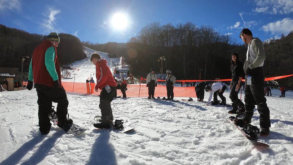 Close up of instructors giving snowboarding lessons on a sunny day at Ober Gatlinburg in Gatlinburg, Tennessee, USA