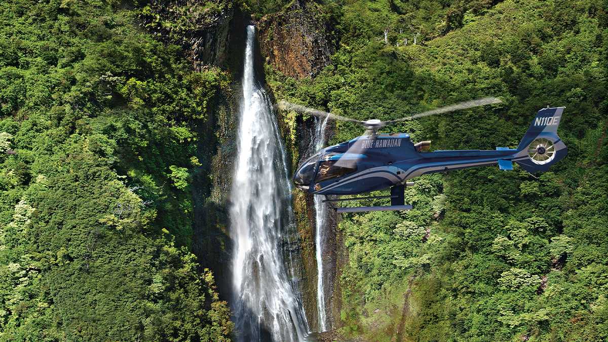 Aerial View of a waterfall and Blue Hawaiian Helicopter Tours - Kauai, Hawaii, USA