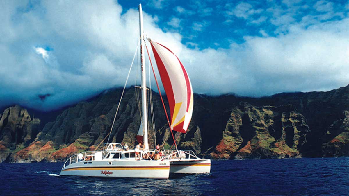 Close up of sailboat along the Na Pali Coast with Captain Andy's Poipu Sunset Sail in Kauai, Hawaii, USA