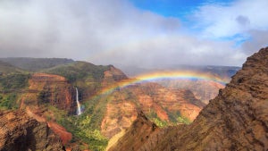 aerial view of rainbow over Waimea Canyon State Park in Kauai, Hawaii, USA