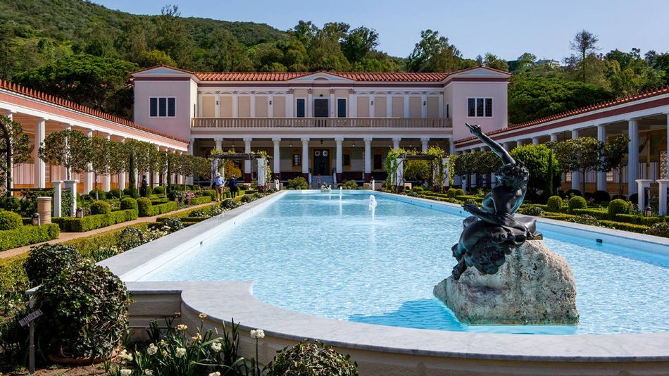 View of pool and statue at The Getty Villa at the Pacific Palisades neighborhood in Los Angeles, California USA