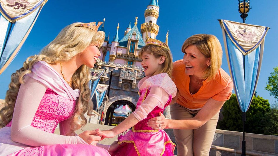 Girl and Mom Standing with Sleeping Beauty at Disneyland castle in Los Angeles, California, USA