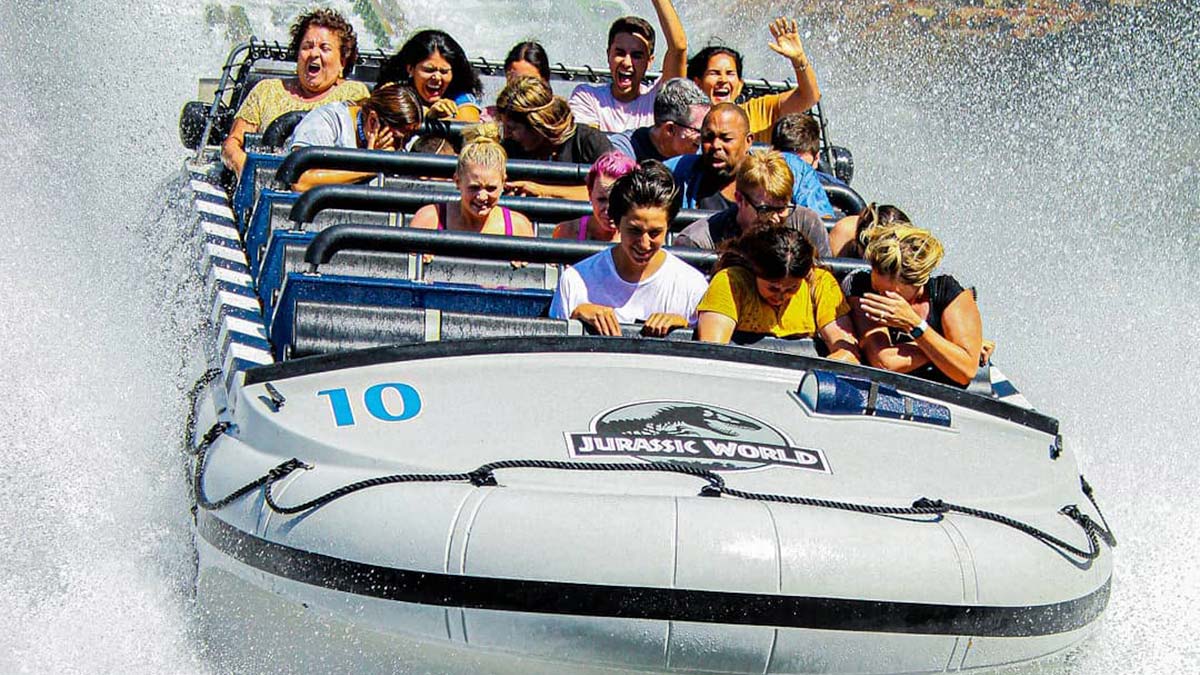 People splashing in the water on the Jurassic World ride at Universal Studios Hollywood in Los Angeles, California, USA