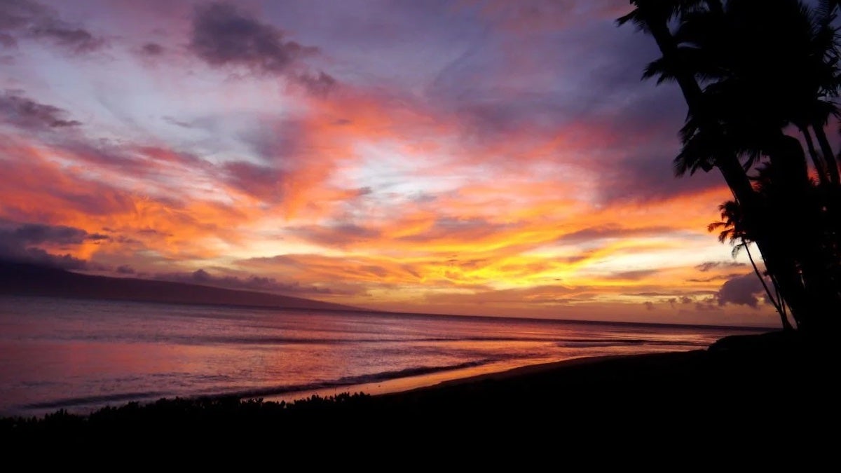 sunset over Maui, Hawaii with hues of orange red and purple