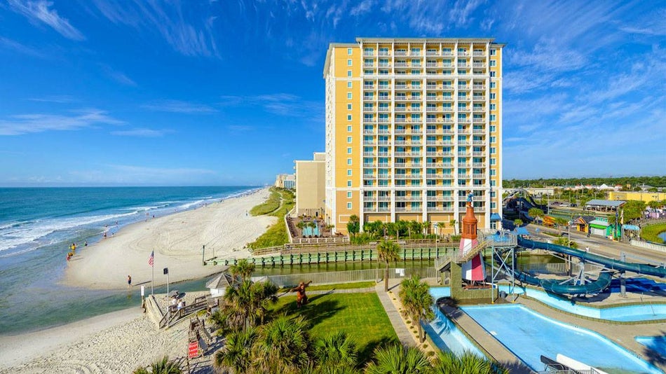 exterior of Westgate Myrtle Beach Oceanfront Resort with view of shore and water during sunny day with blue sky in Myrtle Beach, South Carolina, USA