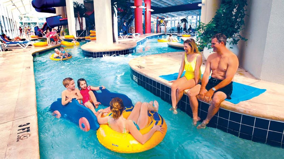 Families playing at the aquatic center and kids floating down the lazy river at Dunes Village Resort - Myrtle Beach, South Carolina, USA