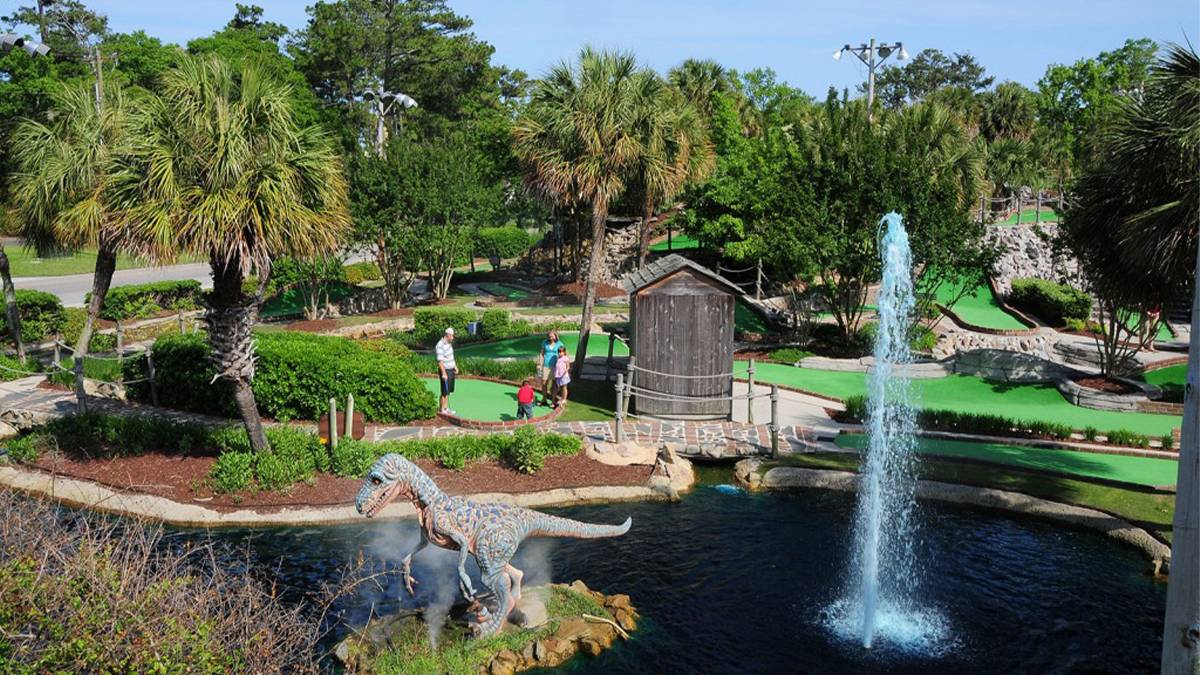 Drone aerial view of fountain and dinosaur at Jurassic Golf in Myrtle Beach, South Carolina, USA